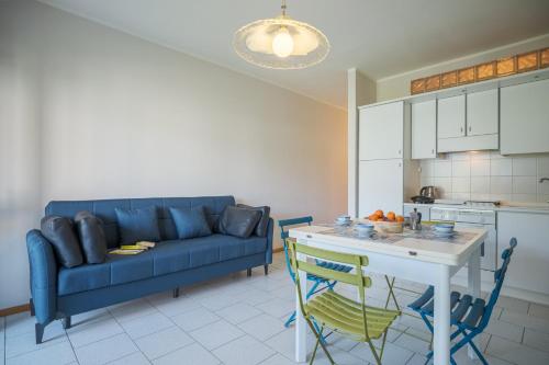 een woonkamer met een blauwe bank en een tafel bij Interno 2 in Iseo