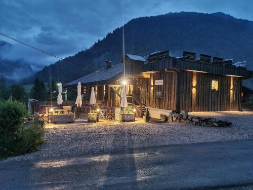 a log cabin with lights in front of it at Le PasSionNant in Morzine