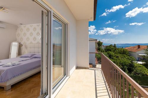 a bedroom with a bed on a balcony at Holiday Home Ninna in Crikvenica