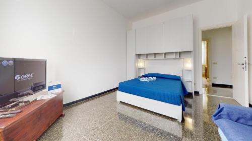 a bedroom with a bed and a tv and a couch at House Azzurra by Holiday World in Genova