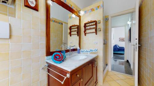 a bathroom with a sink and a mirror at House Azzurra by Holiday World in Genova