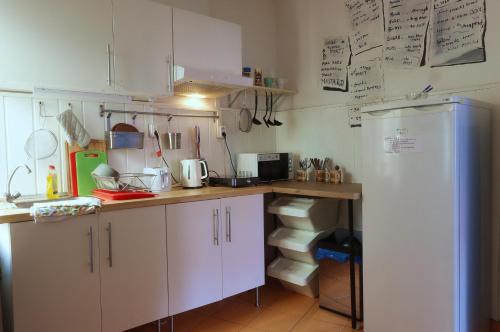 a kitchen with white cabinets and a refrigerator at Hostel Franz Kafka in Prague