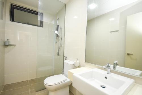 a bathroom with a sink and a toilet and a mirror at Midvalley Southkey Mosaic Suite by Nest Home in Johor Bahru
