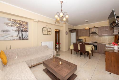 sala de estar y cocina con sofá y mesa en Melissa Luxury Apartments, en Agios Leon