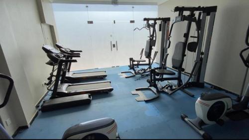 a gym with several tread machines in a room at Hayat Redwa Hotel in Yanbu