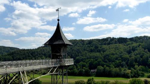 a tower with a cross on top of a bridge at ArtHouse Am Kurpark Bad Schandau in Bad Schandau
