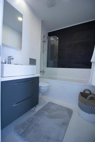 a white bathroom with a sink and a toilet at Single Room A503 StayInn by Cosmopolis in Ştefăneştii de Jos