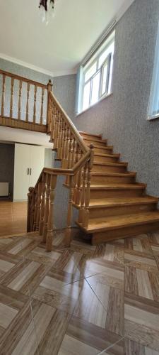 a wooden staircase in a room with a wooden floor at Qusarda günlük kiraye əv,Guest house for the rent Shahdag Kusary in Qusar