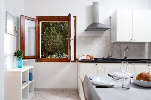 a kitchen with a table and a window in it at Roero Home in Rena Majore