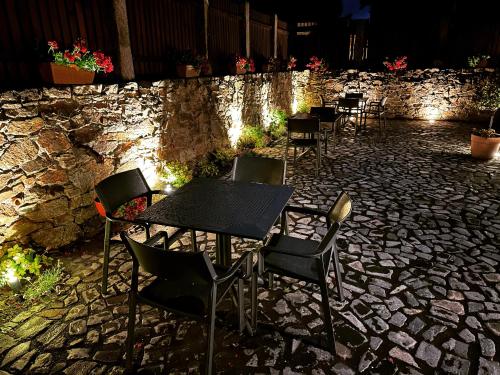 a group of tables and chairs on a stone patio at Pensjonat Dom Zegarmistrza in Bogatynia