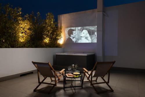 a patio with a table and two chairs and a screen at Athens Flair in Athens