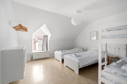 a bedroom with two bunk beds and a ladder at - Duin 63 - Ruim 8 pers duplex app met terras in Koksijde