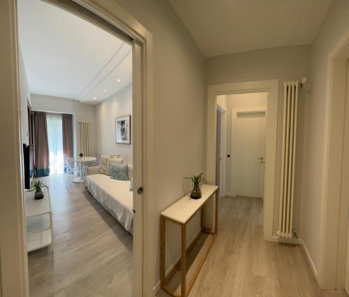 a bedroom with a bed and a room with a mirror at Residence Lungomare - Charming apartments in Riccione