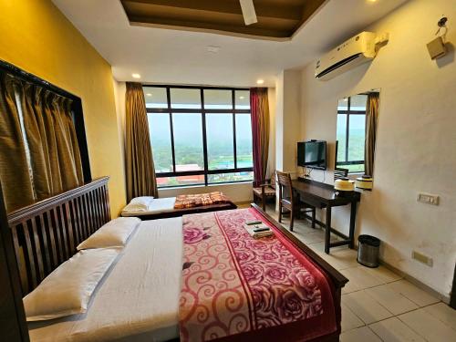 a bedroom with a bed and a desk with a piano at Suman Cottage & Bungalow in Mahabaleshwar