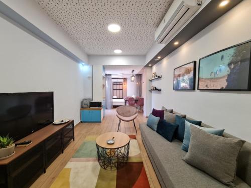 a living room with a couch and a tv at Suite4u in Eilat