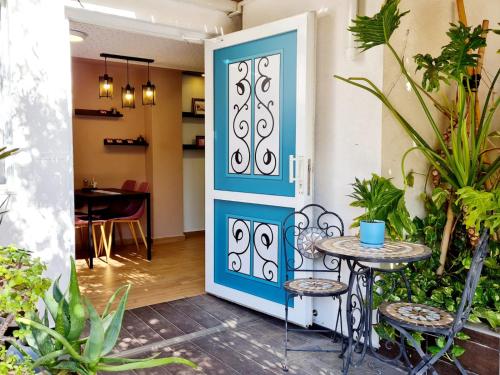 a blue door with a table and chairs in a room at Suite4u in Eilat