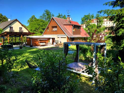 a yard with a house and a playground at Apartmán v podzámčí in Rychnov nad Kněžnou