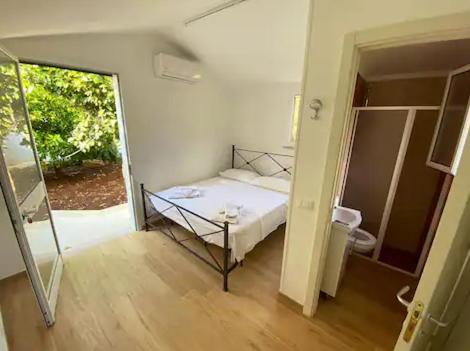 a bedroom with a bed and a door to a bathroom at Villa Adelaide in Ceglie Messapica