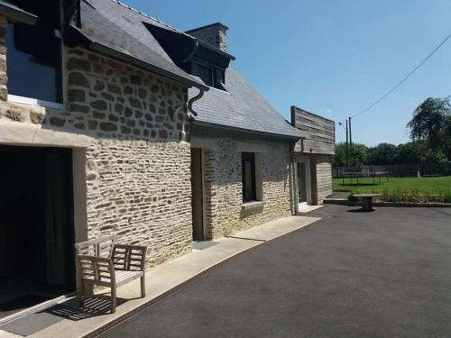 a brick building with a bench in front of it at Chez Titian Vue sur le Mont St Michel in Pontaubault