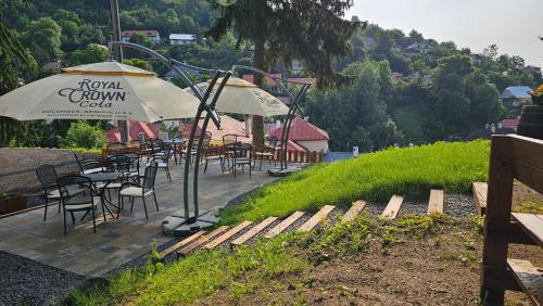 a restaurant with tables and chairs and an umbrella at Black M - Penzión - Reštaurácia in Banská Štiavnica