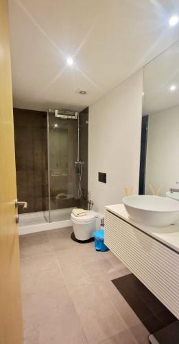a bathroom with a tub and a sink and a toilet at Aveiro Sweet Nest in Aveiro