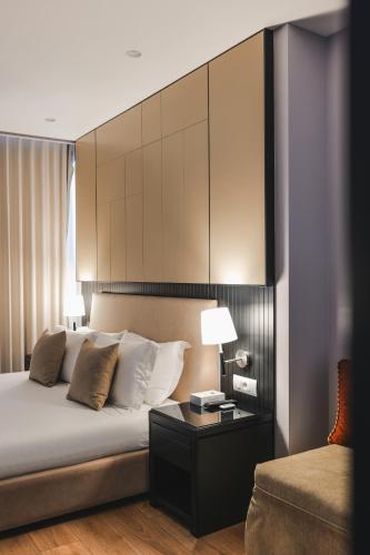 a bedroom with a bed and a table and a couch at Hotel Oasis in Sarandë