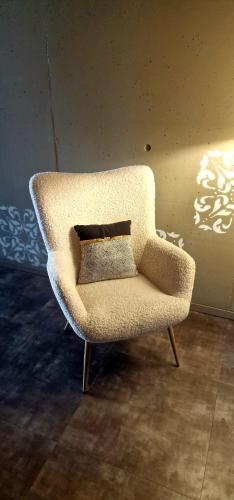 a white chair sitting in a room at Aveiro Sweet Nest in Aveiro