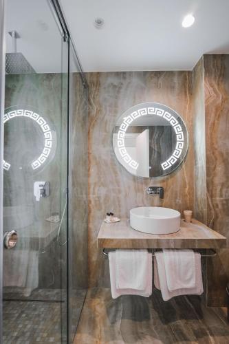 a bathroom with a sink and a mirror at Hotel Oasis in Sarandë