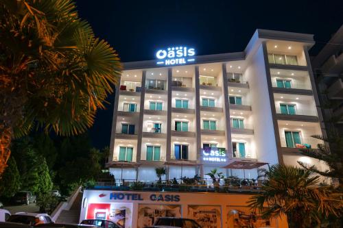 a hotel with a sign that reads odiss hotel at Hotel Oasis in Sarandë