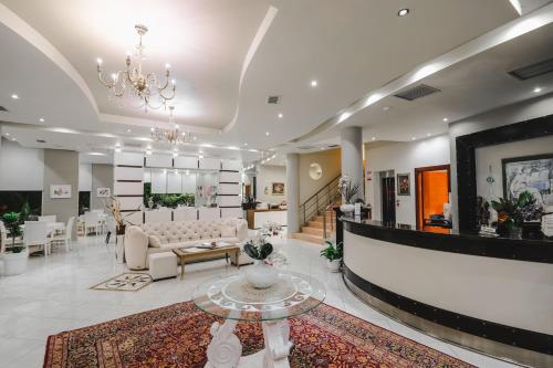 a lobby with a couch and a table at Hotel Oasis in Sarandë