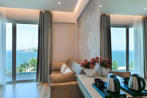 a living room with a couch and a table at Hotel Oasis in Sarandë