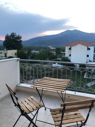 a couple of chairs and a table on a balcony at Soft Pillow in Paralion astros