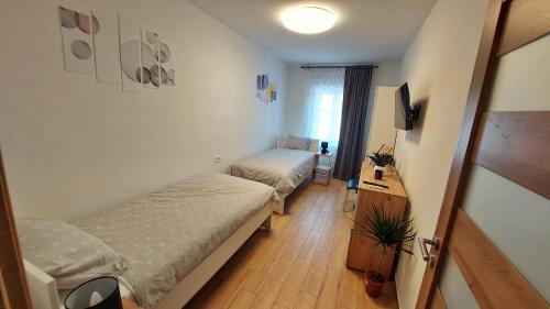 a small room with two beds and a window at APARTMAN Zengg in Senj