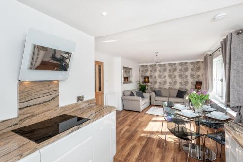 a living room with a table and a couch at Gilmour's Entry Apartment in Edinburgh