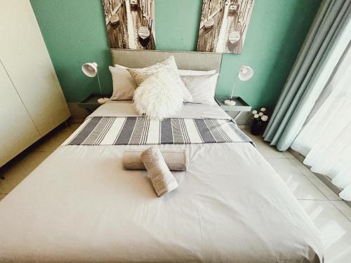 a bedroom with two beds with towels on them at Mjejane Debs guest house in Hectorspruit