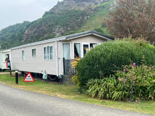 a small white caravan on the side of a road at Bryn Morfa Holiday Park Conwy North Wales in Conwy