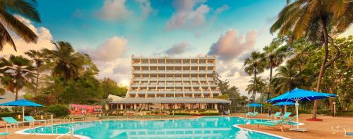 a hotel with a pool in front of a building at The Resort in Mumbai