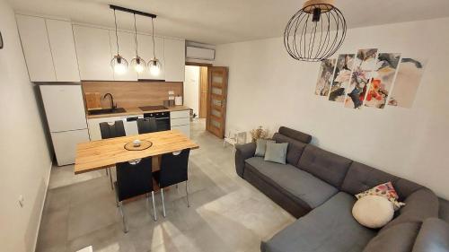 a living room with a couch and a table at APARTMAN Zengg in Senj