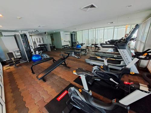 a gym with rows of exercise bikes and treadmills at 5A-Short-term rental allowed-2BRs Downtown Bangkok in Makkasan