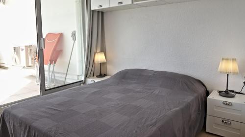a bedroom with a bed and a large mirror at Residence Ulysse Port Camargue in Le Grau-du-Roi