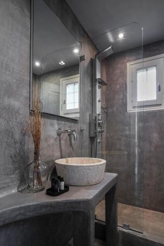 a bathroom with a sink and a glass shower at Agapitos Villas & Guesthouses in Agios Ioannis Pelio