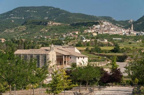 a large building in the middle of a mountain at Santuario Virgen de la Fuente in Peñarroya de Tastavins