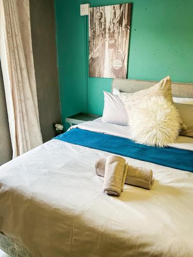 a bed with two pillows on top of it at Mjejane Debs guest house in Hectorspruit