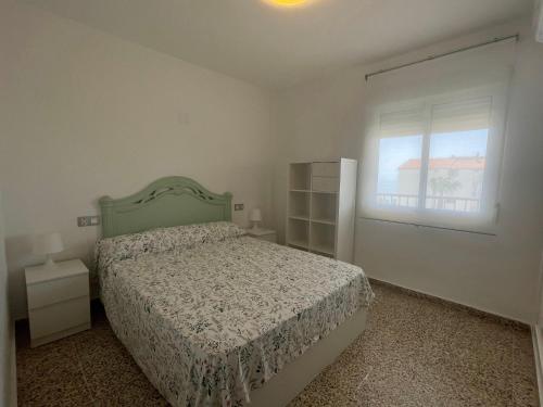 a white bedroom with a bed and a window at Rincon de la Victoria - PMay in Rincón de la Victoria