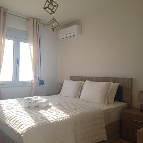 a bedroom with a bed with towels on it at Ionian Avra Apartment in Athani