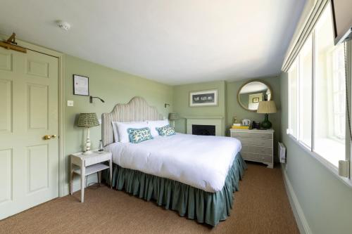 a bedroom with a white bed and a window at The Barnsdale, Rutland in Oakham