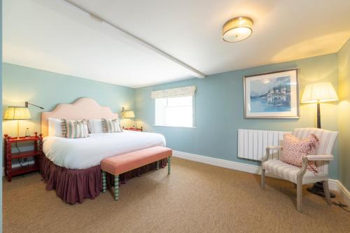 a bedroom with a large bed and a chair at The Barnsdale, Rutland in Oakham
