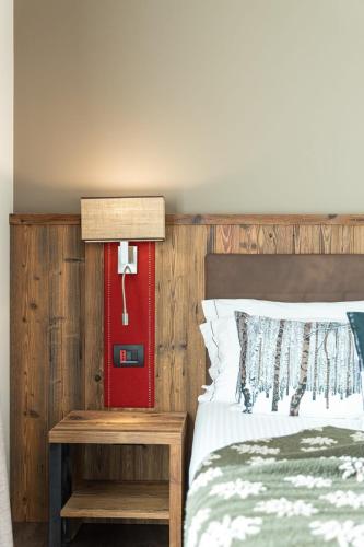a bedroom with a bed and a red door at Olimpia Hotel in Bormio