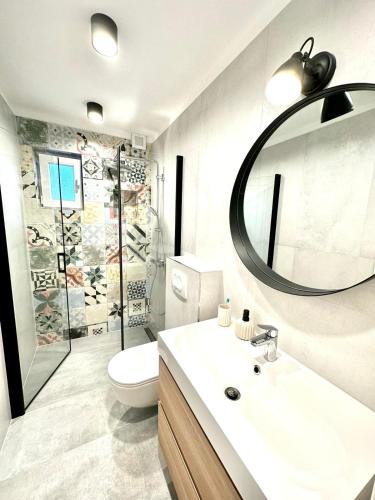 a bathroom with a sink and a toilet and a mirror at House Roki in Vis