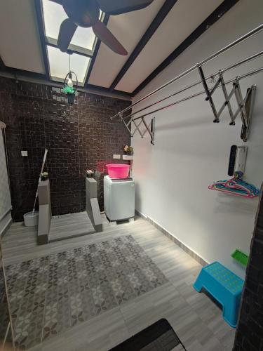 a bathroom with a toilet and a pink sink at Ammara Homestay in Pasir Gudang